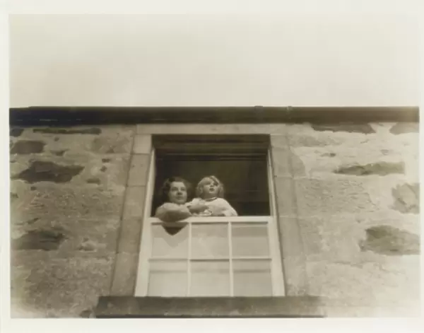 Mother and daughter looking out of window, Scotland
