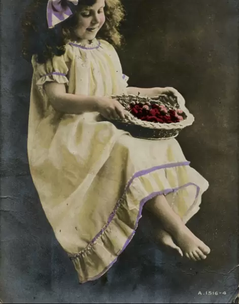 Little girl in yellow dress with basket of fruit