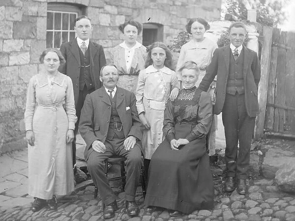Family group in cobbled courtyard, Mid Wales