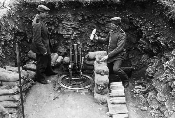 Two soldiers loading a mortar