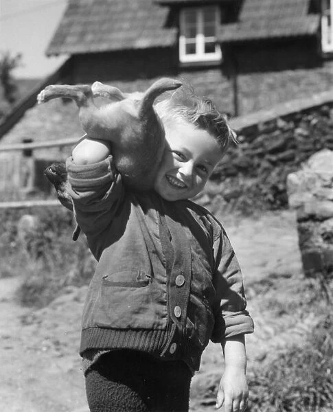 Young boy playing with a puppy