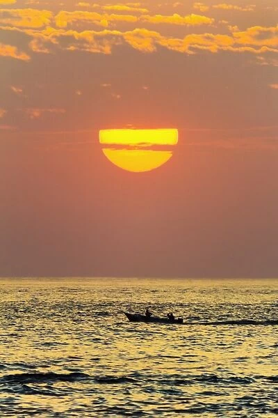 Fishing boat and sunset off Playa Guiones surf beach, Nosara, Nicoya Peninsula, Guanacaste Province, Costa Rica, Central America