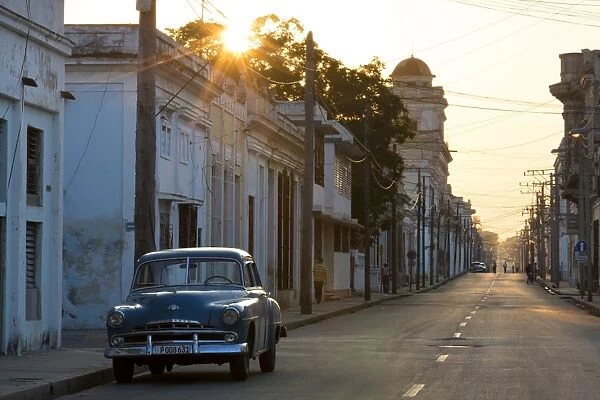 Street scene at sunrise with vintage American car, Cienfuegos, UNESCO World Heritage Site, Cuba, West Indies, Caribbean, Central America