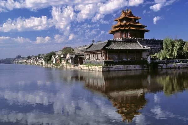 Asia, China, Beijing. A brightly-roofed tower and wide moat guard the entrance to