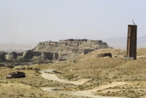 Buy Military graveyard and one of two 12th century minarets that served as models for the Minaret of Jam, with ancient city walls and Citadel in the background, Ghazni, Afghanistan,