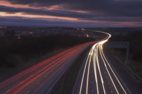 Buy Traffic light trails in the evening on the M1 motorway