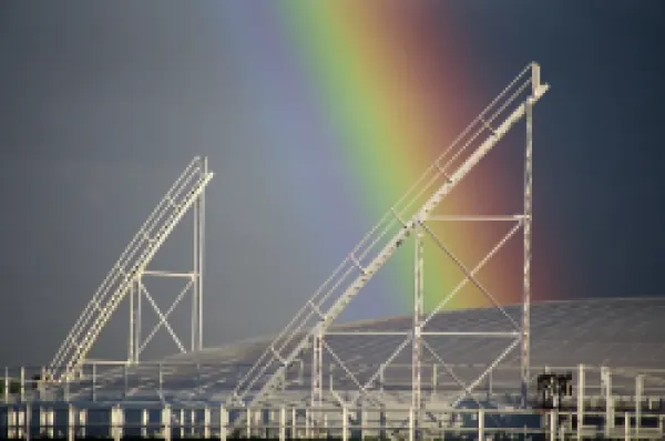 Buy Close-up of the end of a rainbow over a gasometer at Richmond