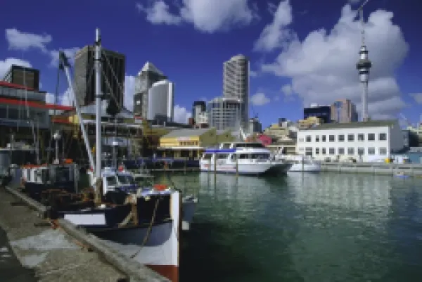 Buy Boats on waterfront with skyline including Sky City Tower beyond
