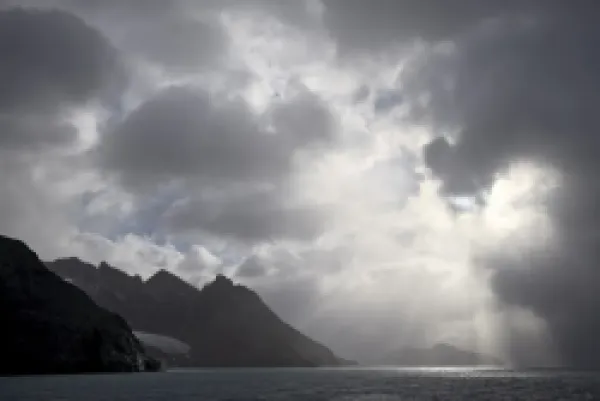 Buy Mountainous coastline near Drygalski Fjord with cloudy skies