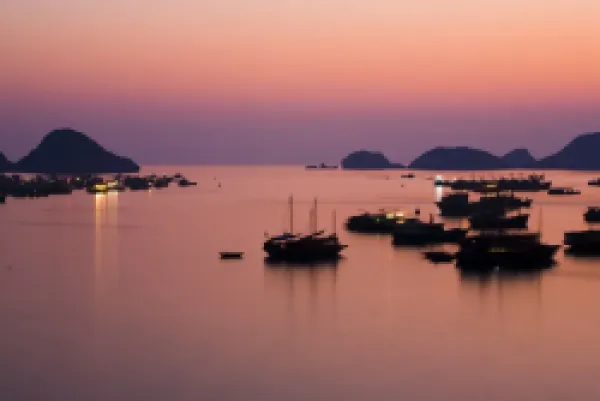 Buy Vietnam, Northern Vietnam, Halong Bay. The pink sunset afterglow at dusk over Cat Ba harbour on Cat Ba Island.