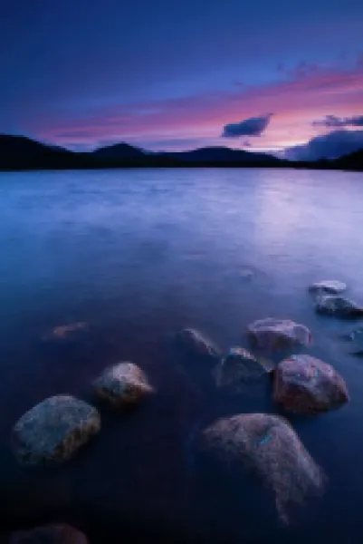 Buy Scotland, Scottish Highlands, Cairngorms National Park. Deep red clouds above Loch Morlich and the surrounding mountains.