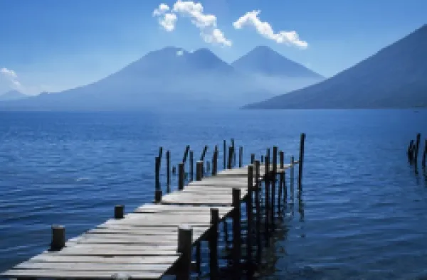 Buy Fishing jetty on Lake Atitlan with volcanoes Toliman and Atitlan behind.