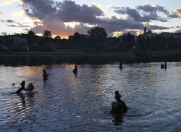 Buy Men fish in Antsirabe s lake at dusk using traditional