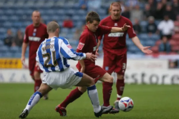 Dean Cox challenges in Midfield