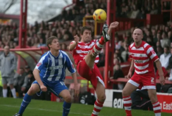 Alex Revell watches Graeme Lee clear the ball