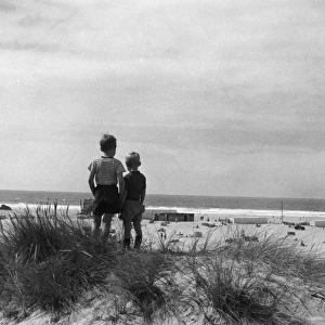 Little boys standing near the beach, Perranporth, Cornwall