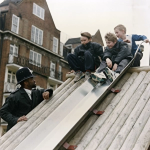 Metropolitan Police officers with boys on slide