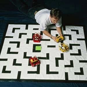 Researcher testing Lego robots playing Pacman