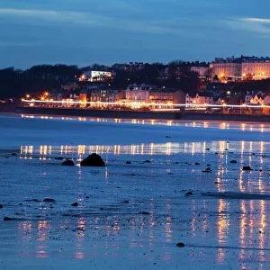 Seafront illuminations reflected on wet sands, Filey, North Yorkshire, England, United Kingdom, Europe