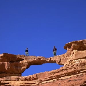 Tourists climbing at Wadi Rum, Jordan, Middle East