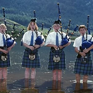 Young pipers cooling down in the loch during a break