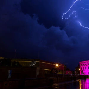 Lightning streaks are seen during a storm over the Auberge de Castille, the office