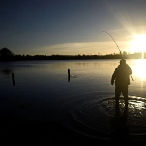 A man is seen fishing at sunset in Lavey Lough near Cavan
