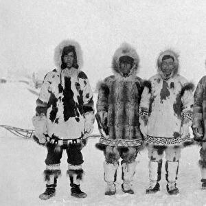 ALASKA: ESKIMOS. A group of six Eskimo men posing in the snow in traditional fur clothing, Alaska