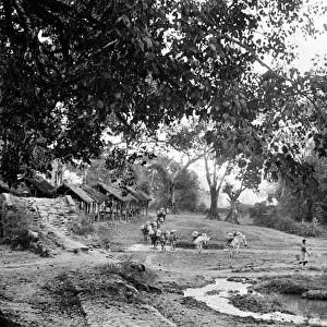 BURMA: BURMA ROAD, c1940. The old Burma Road passing through a village, with a
