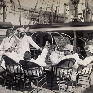 LIFE ON NAVAL SHIP, c1885. Officers relaxing with their feet up on the deck of
