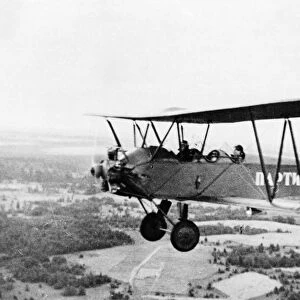 World war 2, a partisan airplane (polikarpov po-2) flying over leningrad territory, the word partisan is written on the side of the plane