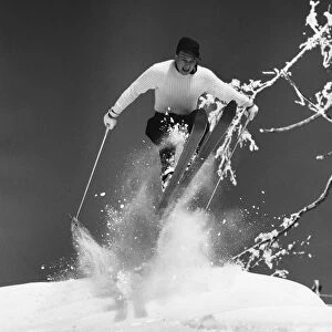 Man jumping through air on skis
