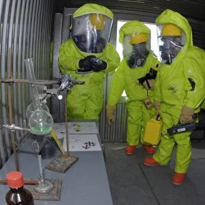 Specialists survey a simulated area during a HAZMAT exercise