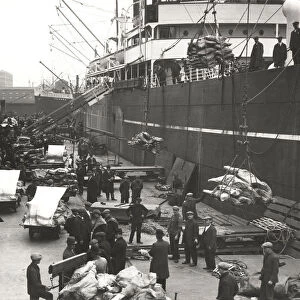 Cargo being loaded or unloaded from a ship, Royal Victoria Dock, Canning Town, London, c1930