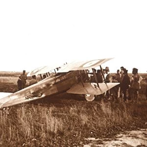 Soldiers surrounding biplane, Somme, northern France, c1914-c1918