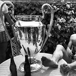 Liverpool footballer Tonny Smith enjoys a bottle of beer as he sits with the famous
