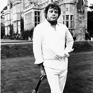 Oliver Reed Film Actor awaits his turn to bat in the grounds of a stately home