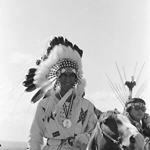 Prince Charles, the Prince of Wales, wearing Indian headdress in Calgary