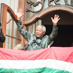 South African President Nelson Mandela waving to the crowds from the balcony of South