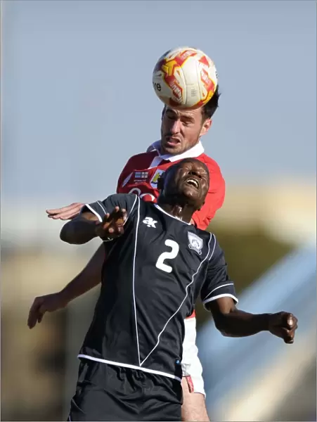 Bristol City's Greg Cunningham vs Extension Gunners Isaac Paete: A Heading Battle in Botswana, 2014