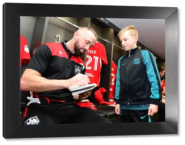 Bristol City's Aaron Wilbraham Signs Autographs for Mascot Before Fulham Clash