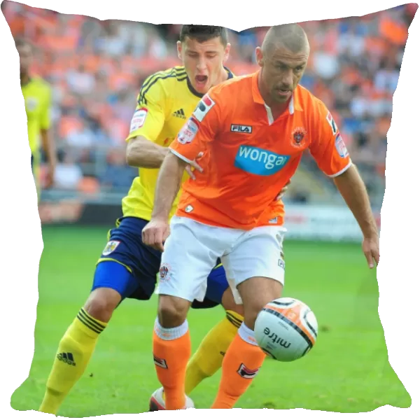 Bristol City's James Wilson vs. Blackpool's Kevin Phillips: Battle for the Ball in 2011 League Cup Match