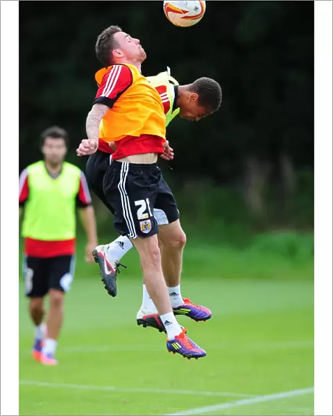 Bristol City Football Club: Paul Anderson and Bobby Reid Compete for High Ball during Training