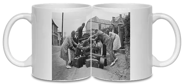 People loading a car at Perranporth, Cornwall