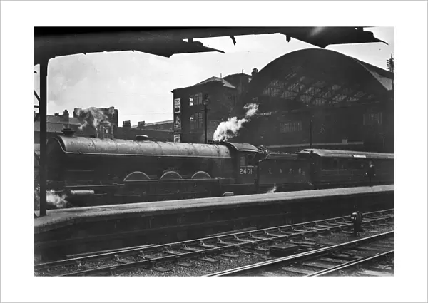 LNER steam engine outside a station