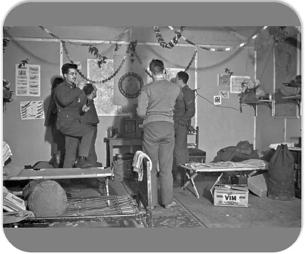 Four soldiers playing darts in an army hut