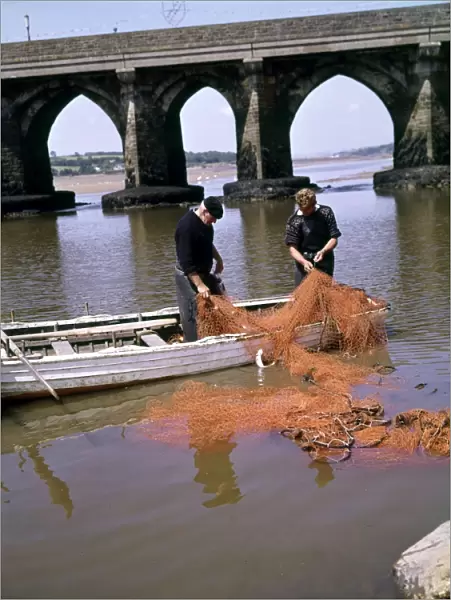 Two men repairing fishing nets, Bideford, Devon