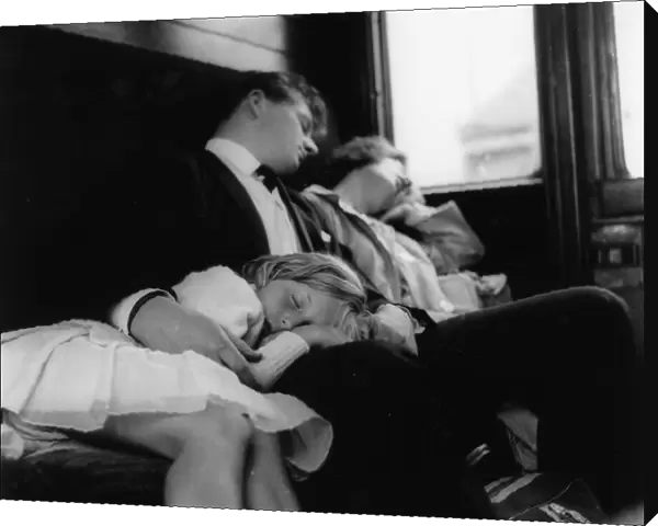 Young couple and child sleeping in a train compartment