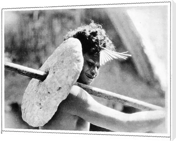 Native of Yap carrying stone money