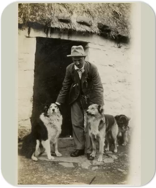Man in Scotland with three collie dogs